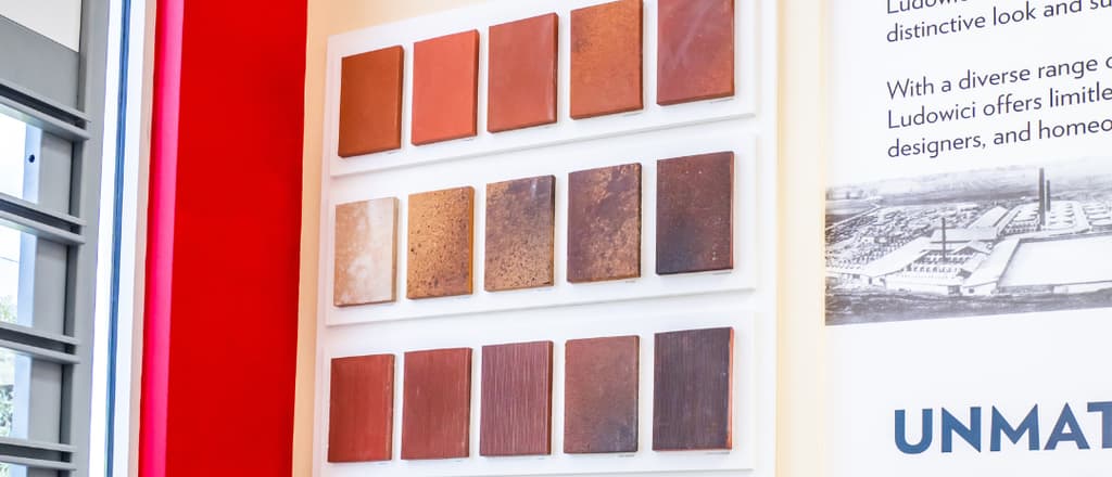 Working sample wall of clay tile finishes inside the Istueta showroom.