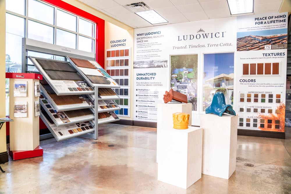 Inside the Istueta Roofing showroom: tile samples, metal panels, and shingle swatches arranged for in-person review.