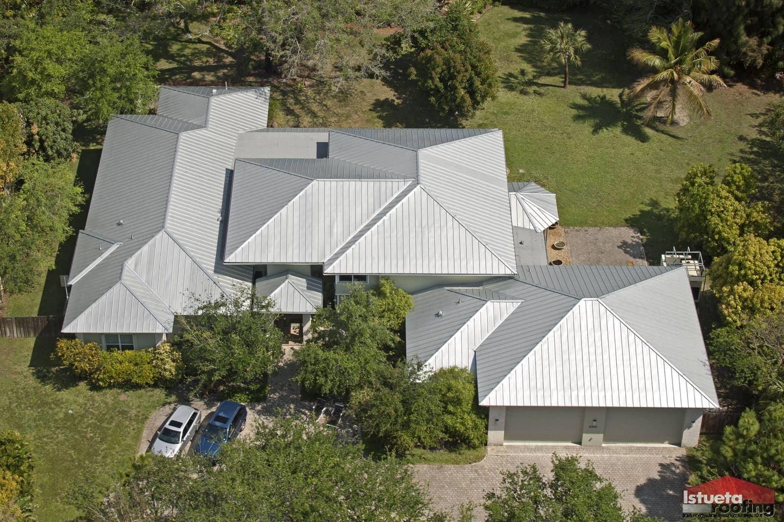 Standing-seam metal roof on a Pinecrest Mediterranean-Modern estate