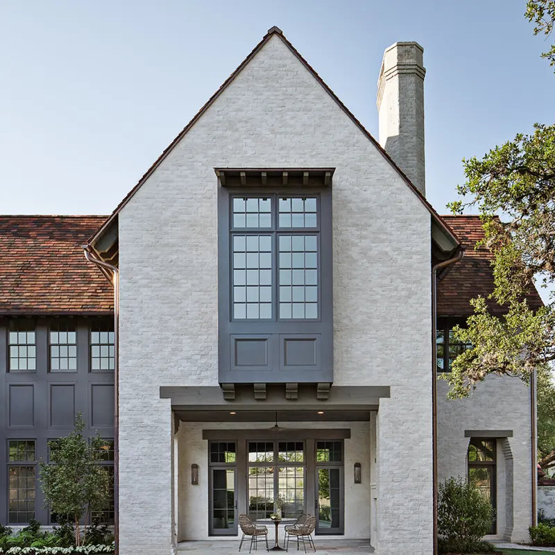 White masonry residence with a variegated Ludowici clay tile roof