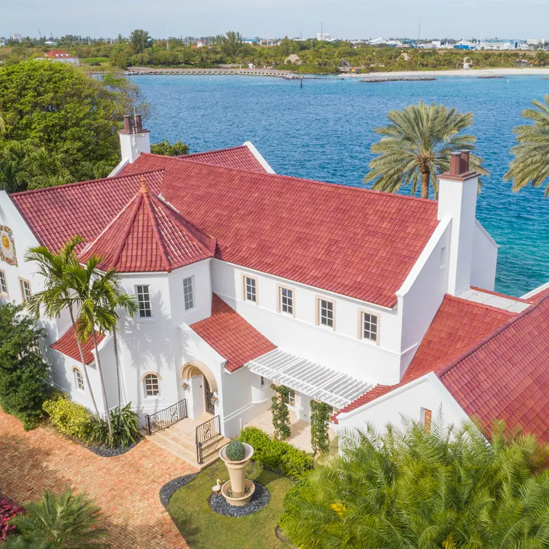 Waterfront residence with a red Ludowici clay tile roof
