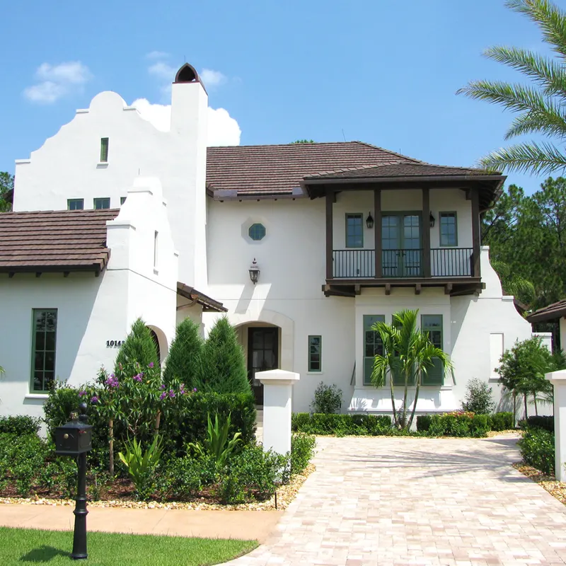 White coastal residence finished with a brown Ludowici clay tile roof