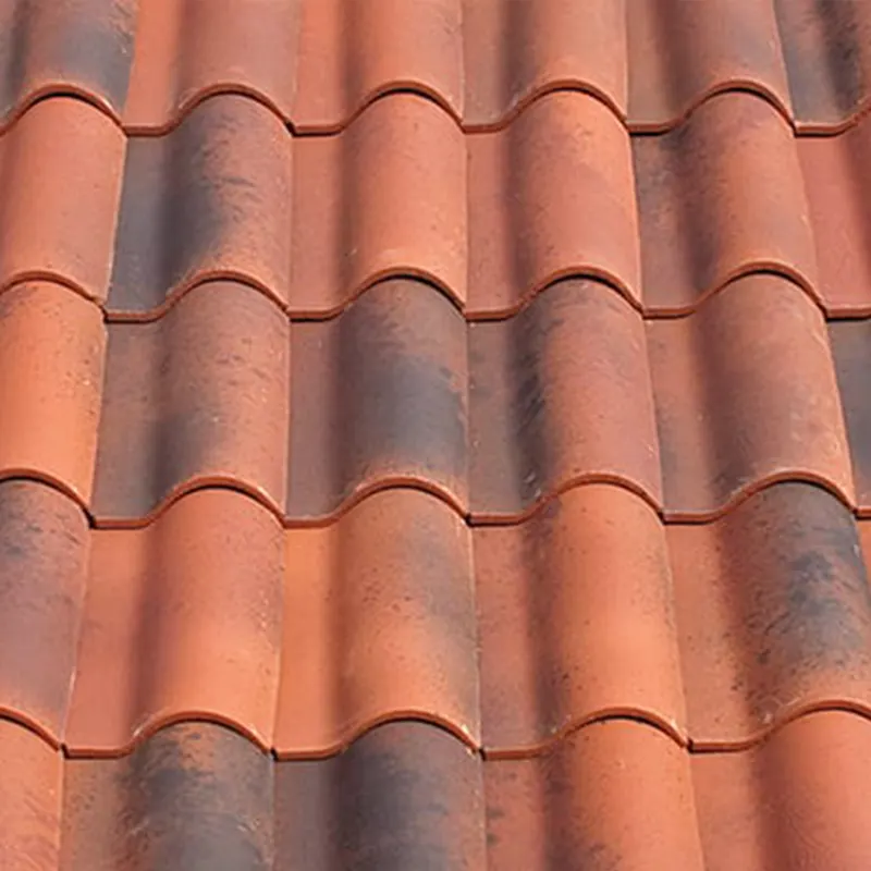 Close view of red barrel clay tiles with a variegated fired finish