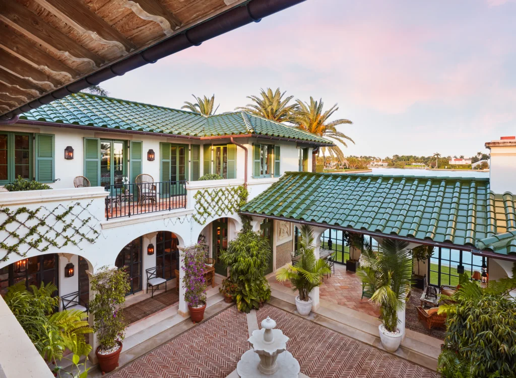 Green Ludowici barrel tile roof surrounding a waterfront courtyard