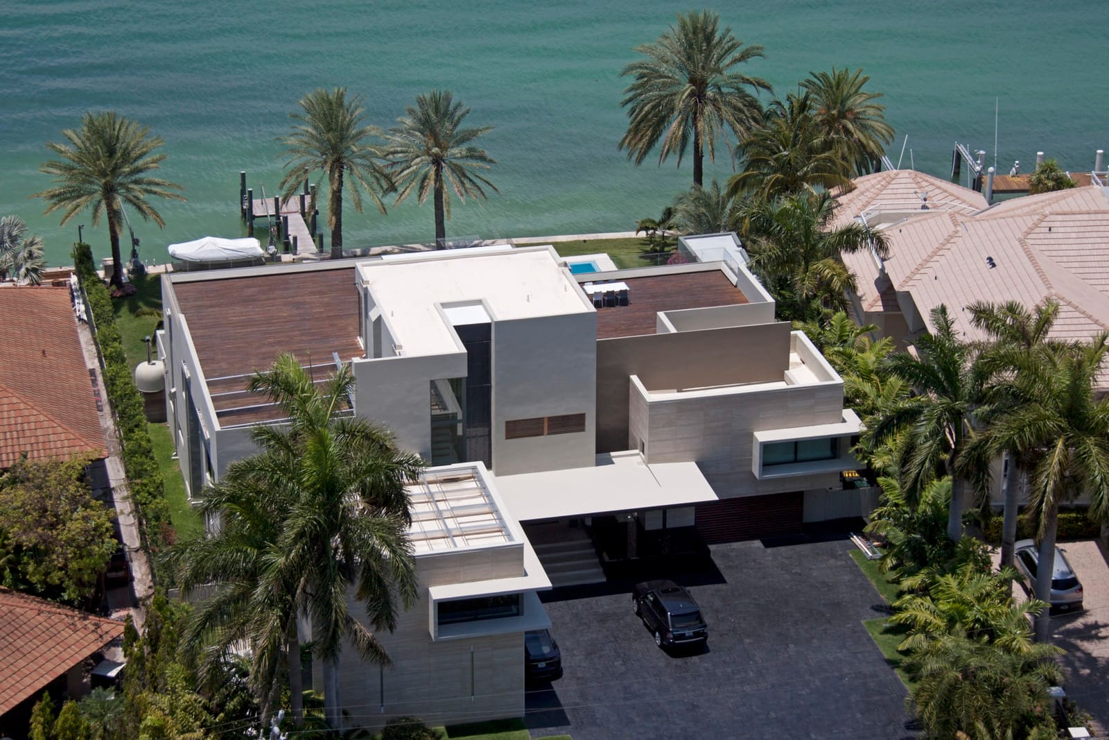 Completed modern flat roof on a waterfront Key Biscayne home by Istueta Roofing, work backed by our transferable 12-year workmanship warranty.