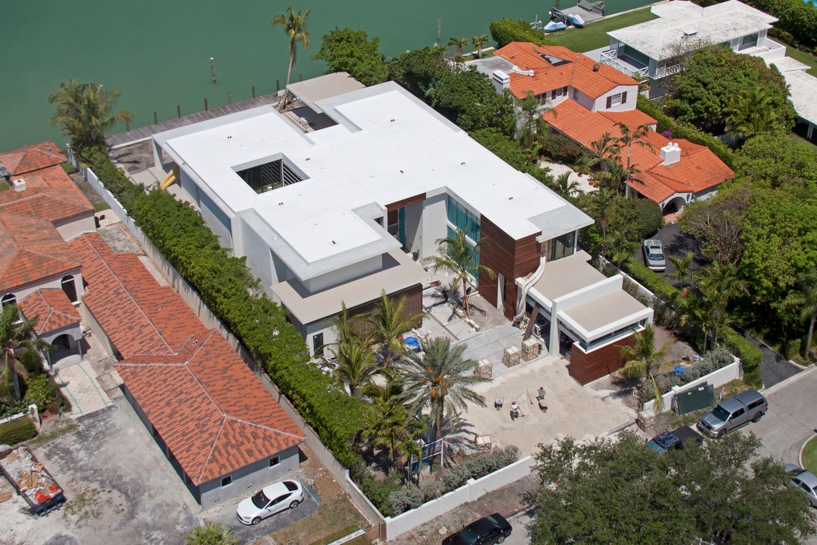 Cool-roof white flat membrane over a low-slope roof section, aerial view.