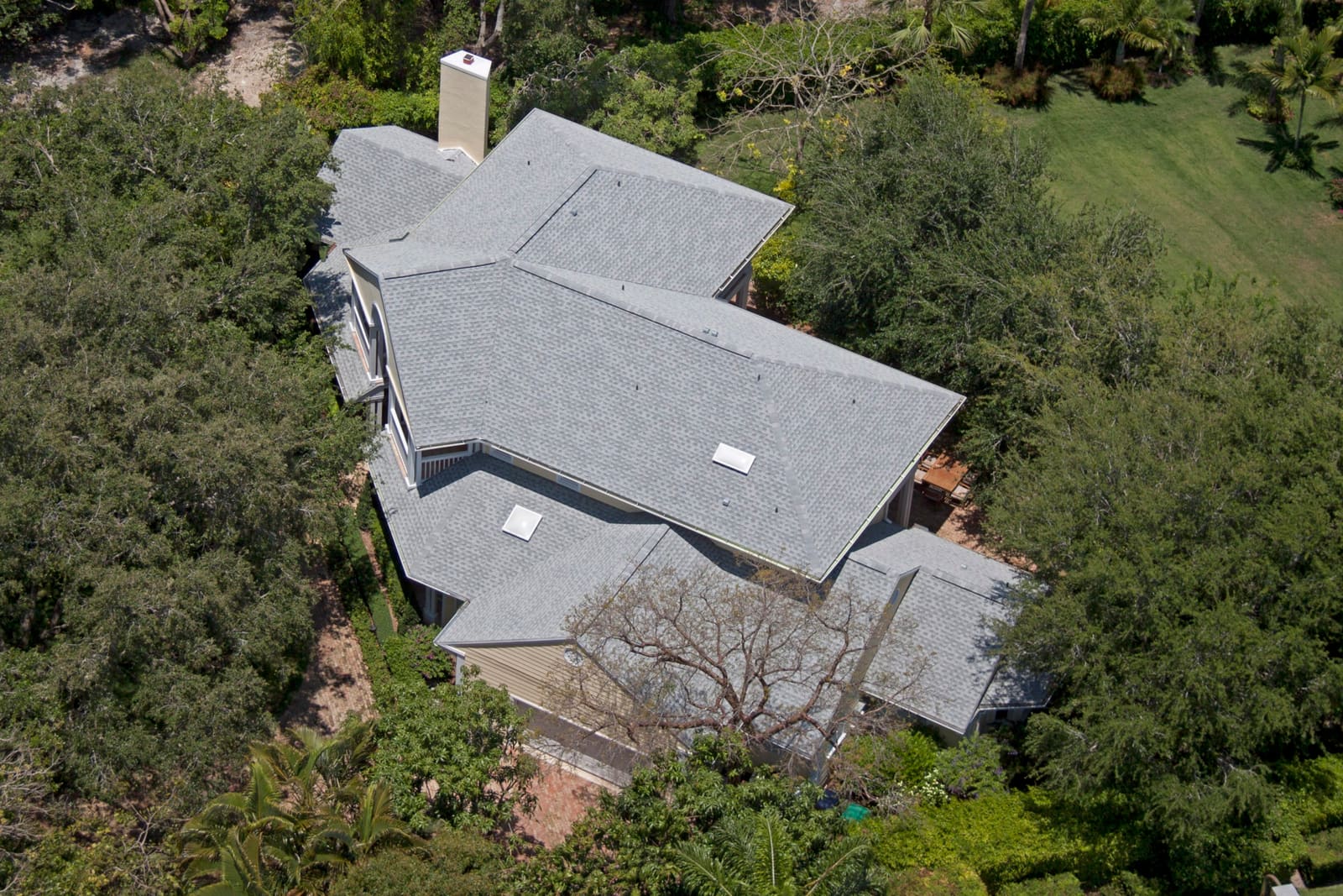 Architectural asphalt shingle roof on a South Florida home, aerial view.
