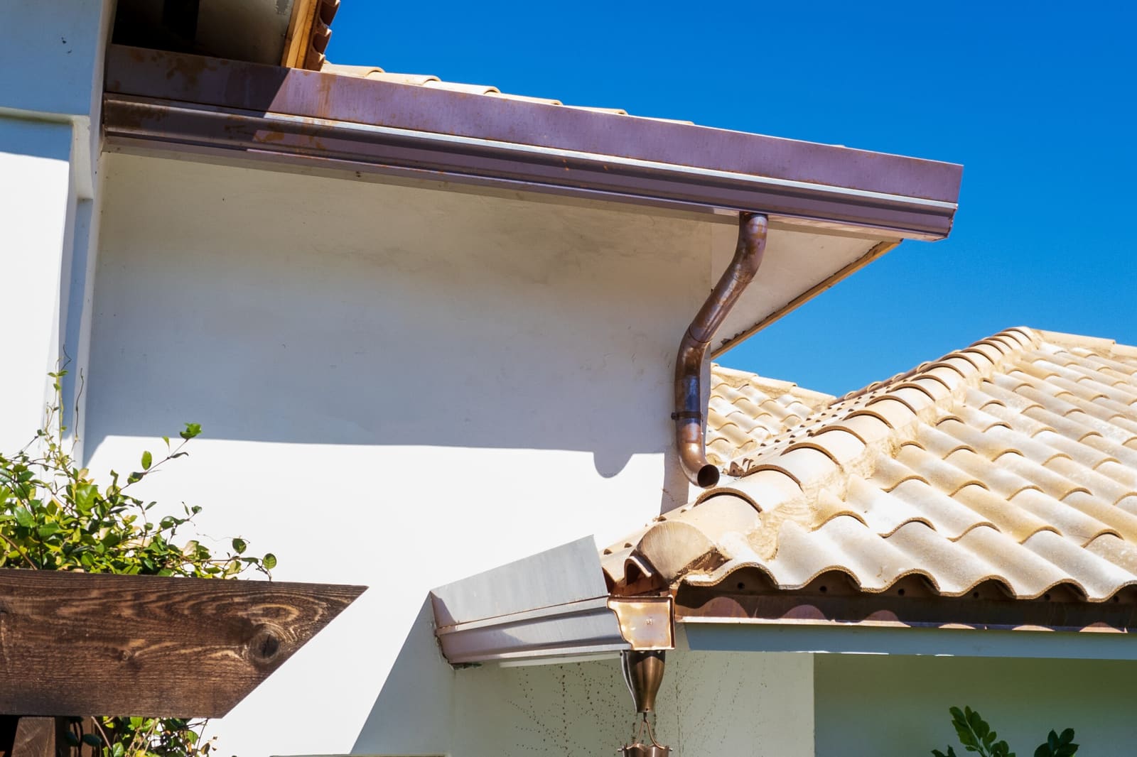 Ludowici barrel clay tile roof with integrated copper flashing and downspout on a Miami Beach home.