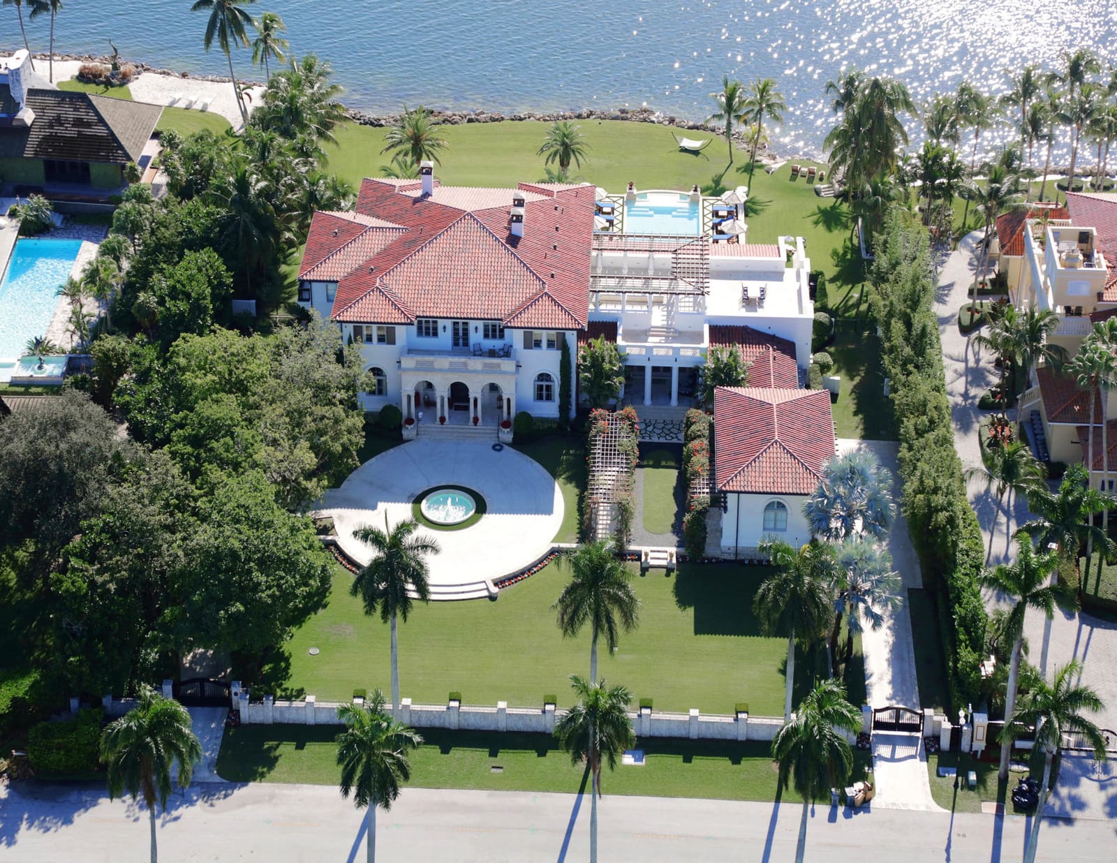 Aerial view of a red Redland clay tile roof on a bayfront Mediterranean estate in Coral Gables
