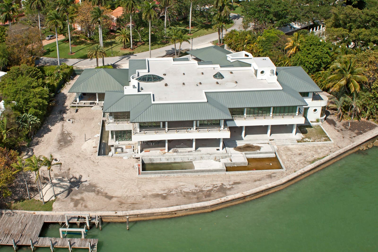 Standing-seam metal roof on a contemporary Miami Beach bayfront estate, aerial view.