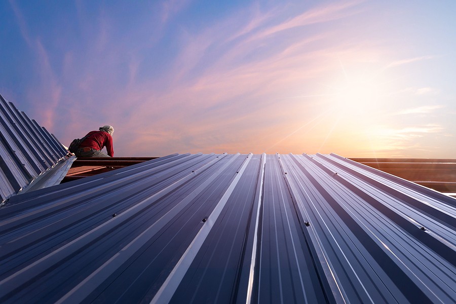 Aluminum standing-seam panel installation showing concealed-clip fastening system, Miami roofing project.