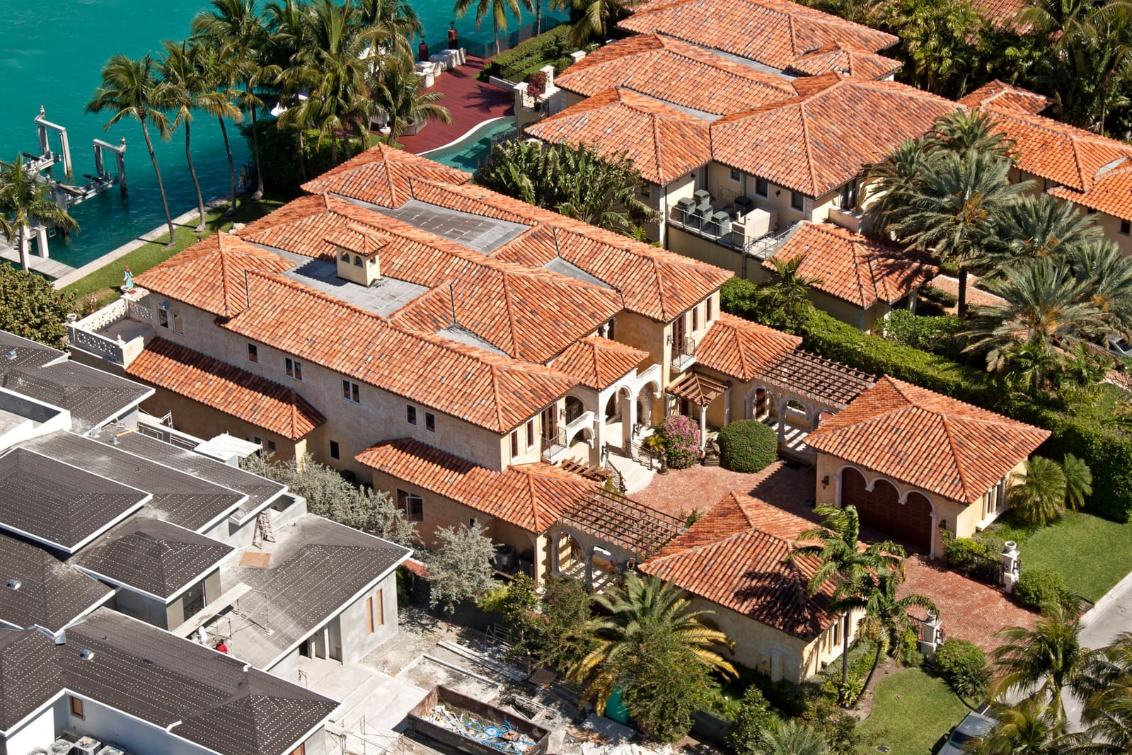 Two-piece Spanish barrel clay tile roof on a Miami Beach-area waterfront estate, aerial view.
