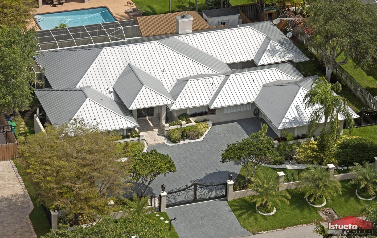 Close-up of galvalume metal roofing panels showing seam detail and metallic coating surface in coastal setting.