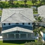 Luxury home with gray asphalt shingle roof