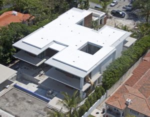 Aerial view of a Florida building with a clean white flat roof